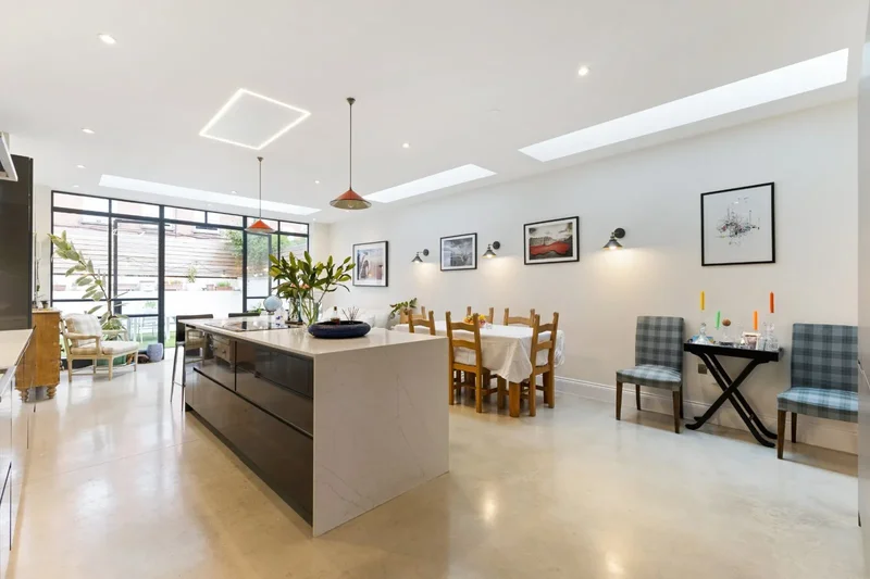 An outstanding five-bedroom home with a striking glass-backed kitchen dining room