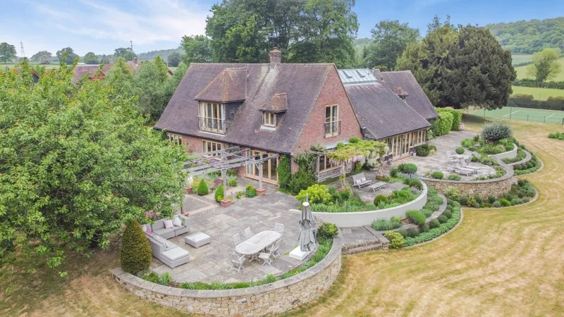 A distinctive country residence with a separate cottage, set within landscaped gardens.